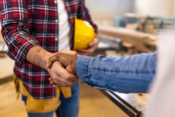 Roofer shaking hands with a homeowner