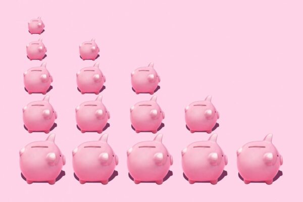 A stack of pink piggy banks going from one in a row to five in a row