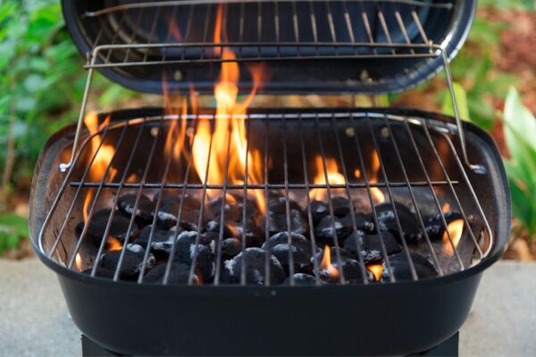 A charcoal grill with briquettes