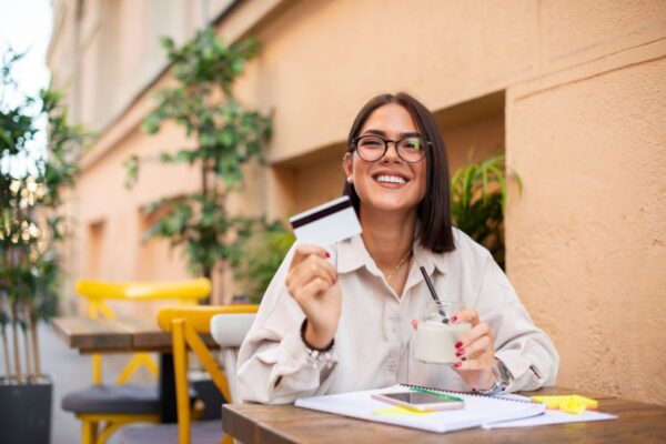 Woman holding up the best business credit card for contractors