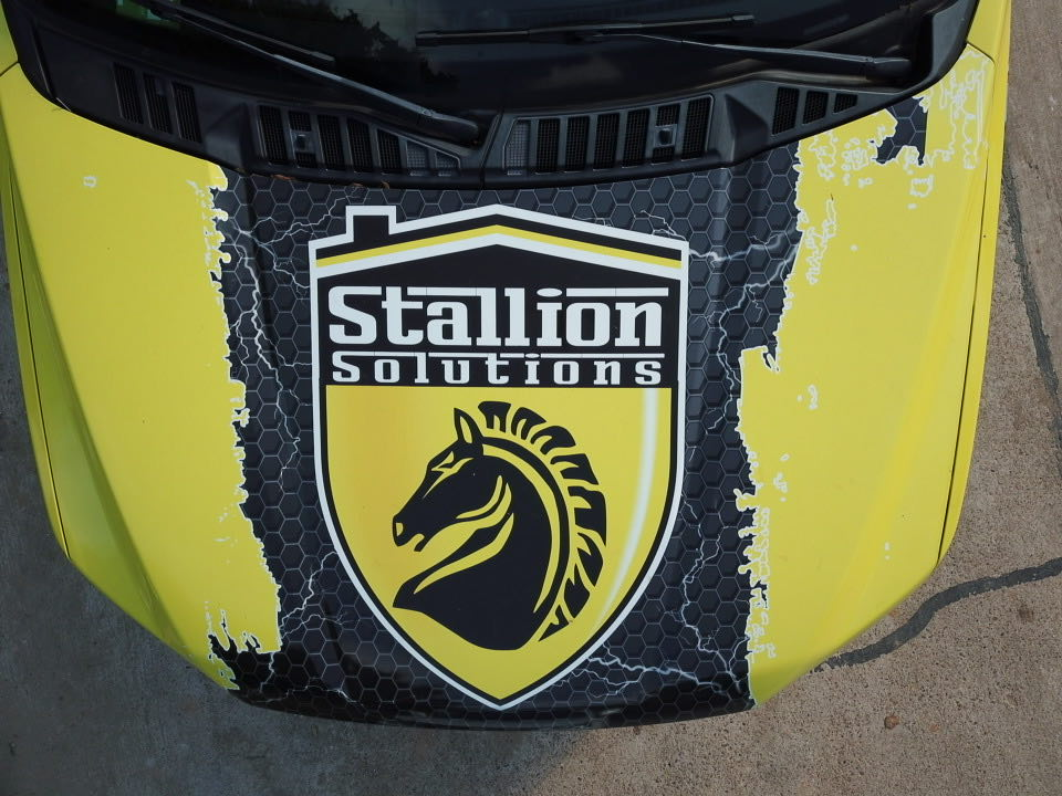 Yellow and black roofing truck hood wrap