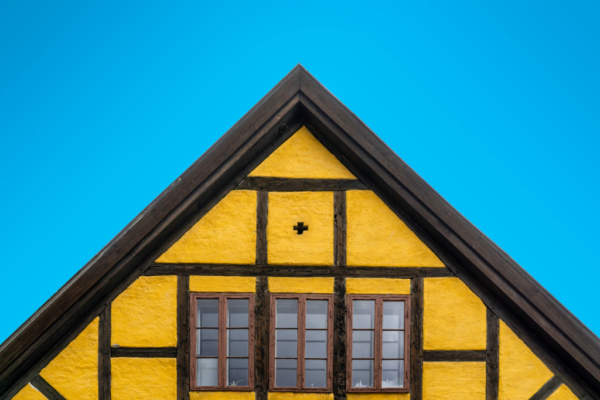 yellow house with steep gable double-pitch roof