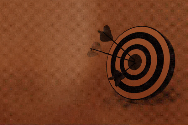An archery target with arrows sticking out the bullseye